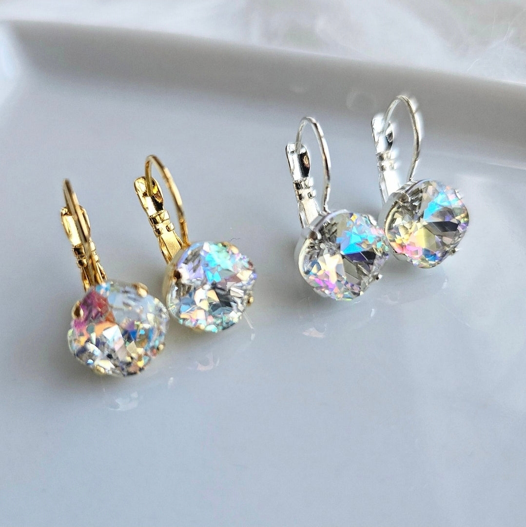 Two pairs of Wixies Iridescent 10mm Cushion Lever Back earrings in silver and gold reflecting vibrant rainbow hues