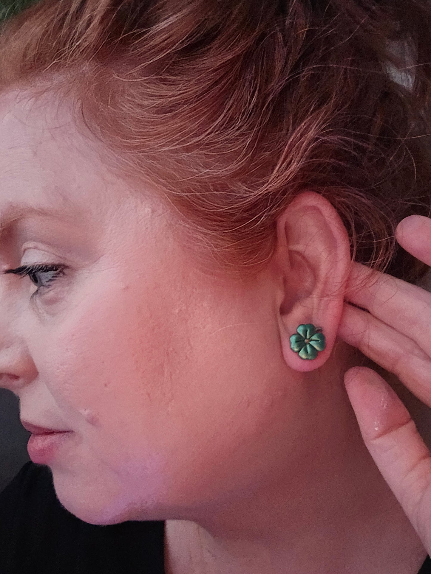 Wixies Shamrock Dangles or Studs shown worn on ear with close-up of green four-leaf design on model
