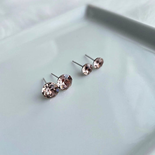 Wixies 8mm or 6mm Vintage Pink Studs with sparkling soft pink stones in stainless steel settings on a light surface