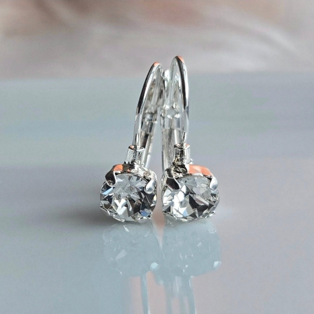 Pair of Wixies "Ice" 8mm or 6mm Lever Back earrings with clear faceted gems sparkling on reflective surface
