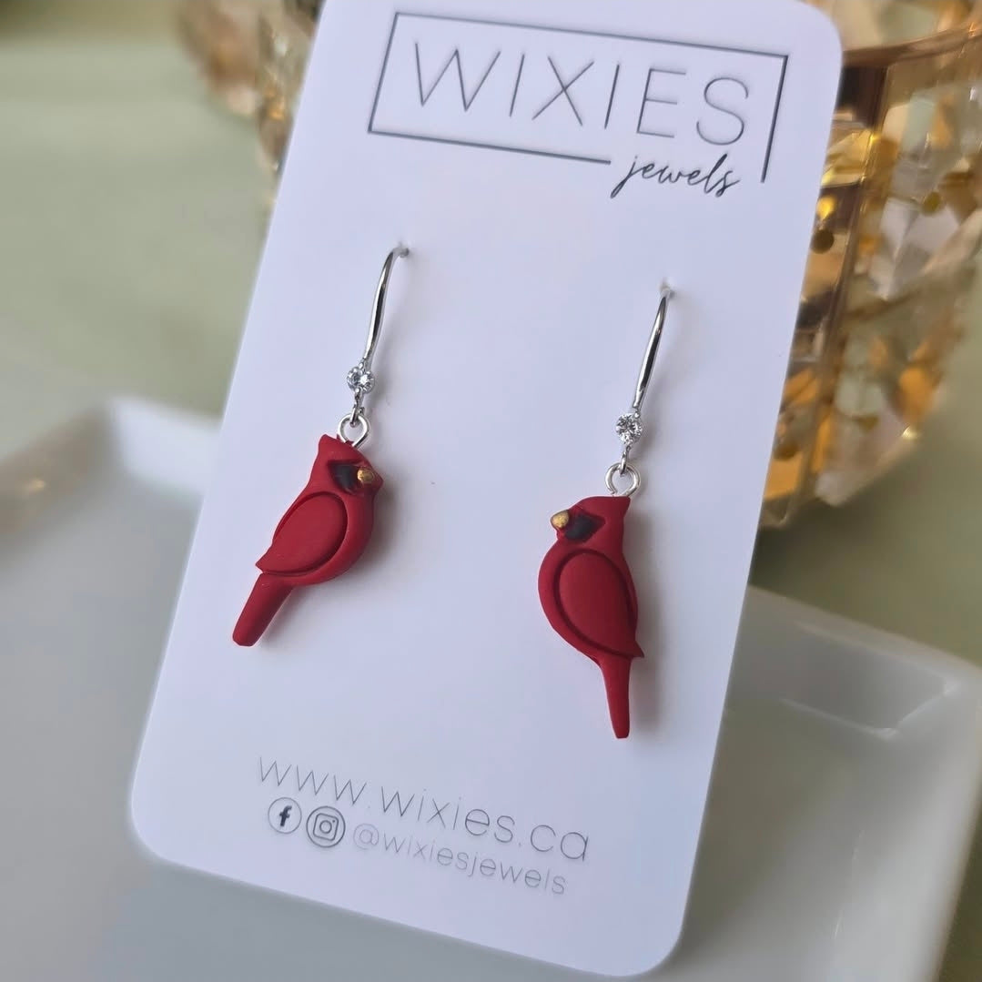 Silver dangle earrings featuring red cardinal birds with cubic zirconia on Wixies Jewels display card