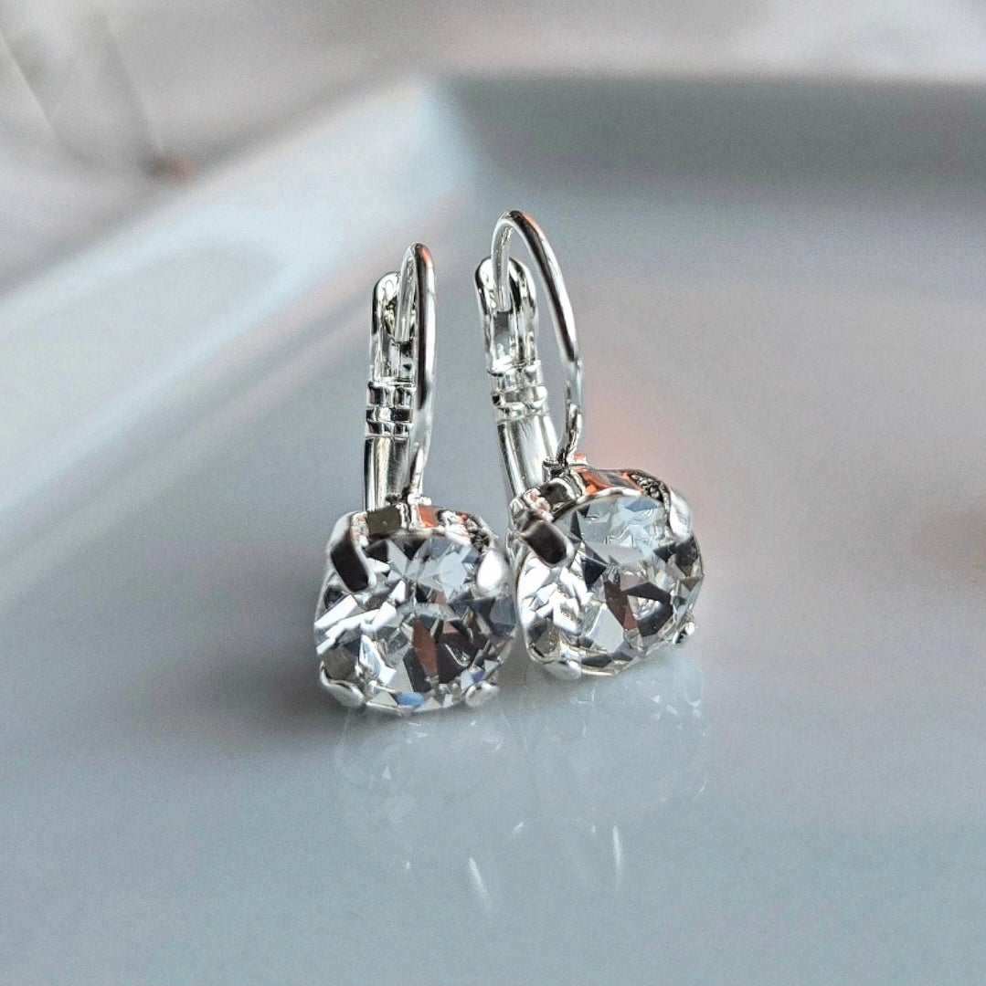 Pair of Wixies "Ice" 8mm or 6mm Lever Back earrings with sparkling clear faceted gems on a smooth reflective surface