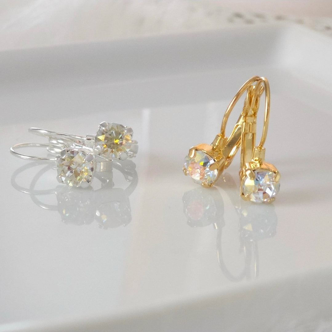 Image features a pair of silver toned french lever back earrings with a 6mm crystal gem and a pair of gold plated french lever back earrings with a 6mm crystal gem.