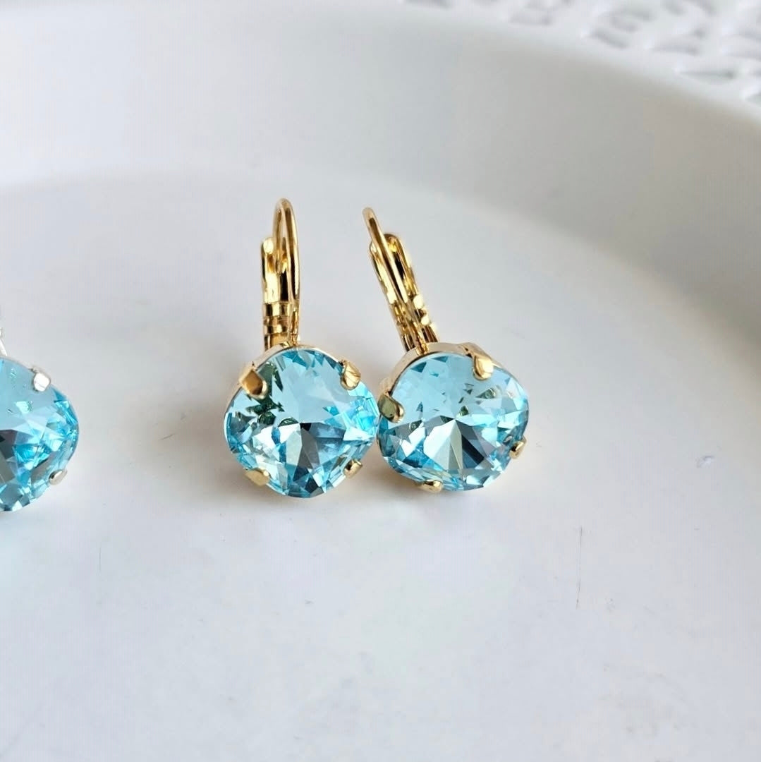 Tahiti Blue Cushion Lever Back earrings by Wixies with radiant blue stones in gold settings Handmade and Picked in Nova Scotia
