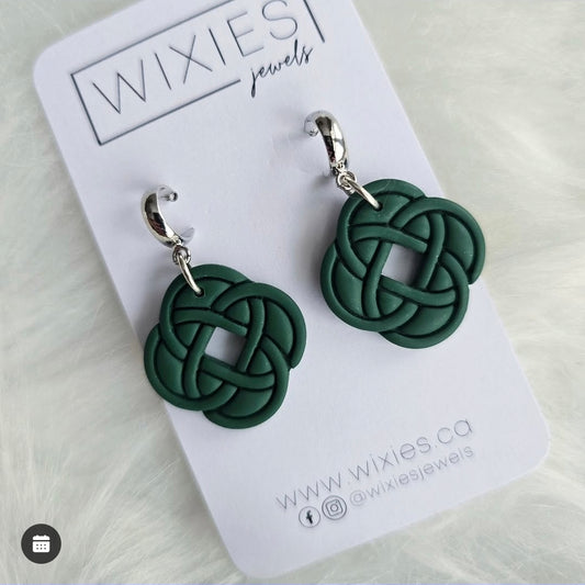 Celtic Knot Dangles by wixies featuring dark green woven knot charms with silver hooks on branded white card background