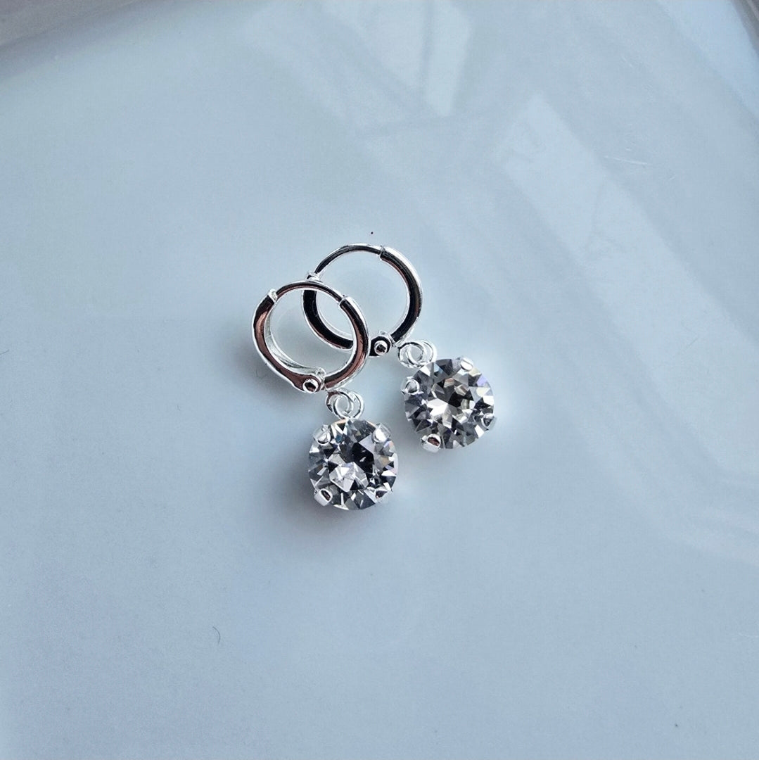 Wixies Huggie Hoops with 8mm Gem featuring clear sparkling stones on a polished silver setting with soft reflections